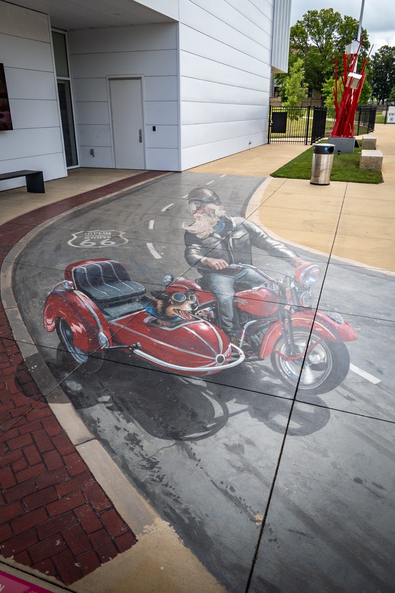 Route 66 3D street art motorcyclist with dog in sidecar painting near S Wall Ave and W 7th St